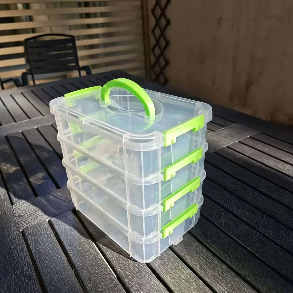 4-layer Transparent Storage Box made of clear plastic with green handles and latches, featuring four stackable compartments