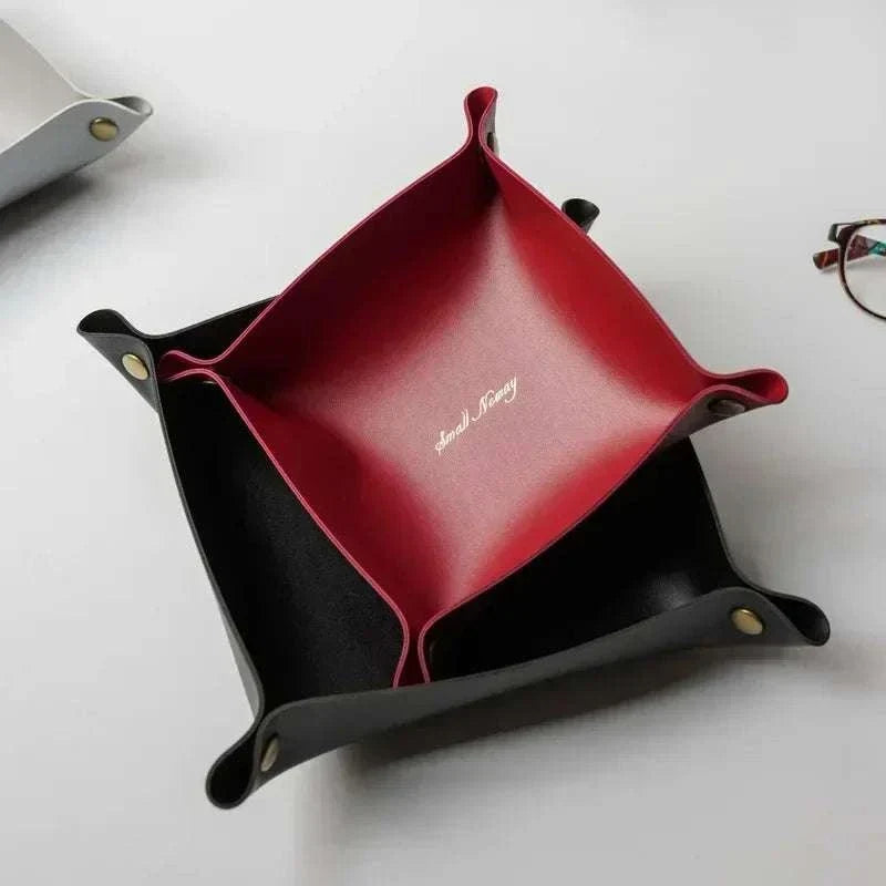 Nordic Leather Desk Tray in black and red faux leather with snap-button corners and embossed logo in the center