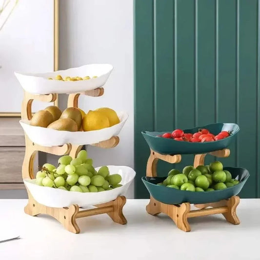 Wooden Multi-Tier Serving Plates featuring stacked white and green ceramic bowls on natural wood stands holding fruits and vegetables
