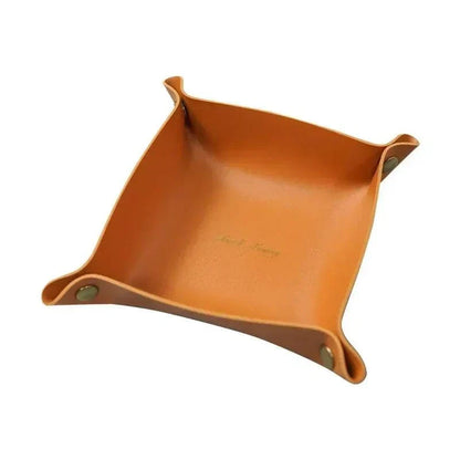 Nordic Leather Desk Tray in tan synthetic leather with folded corners secured by metal snaps, featuring embossed text inside.
