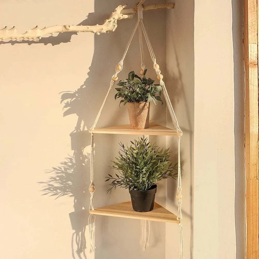 Wooden Triangle Corner Shelf with natural wood finish, hanging design, and two tiers holding potted plants secured by beige ropes.
