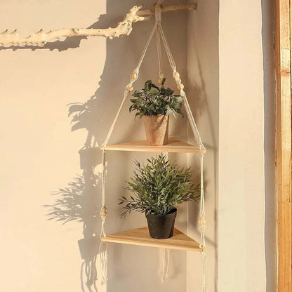 Wooden Triangle Corner Shelf with natural wood finish, hanging design, and two tiers holding potted plants secured by beige ropes.