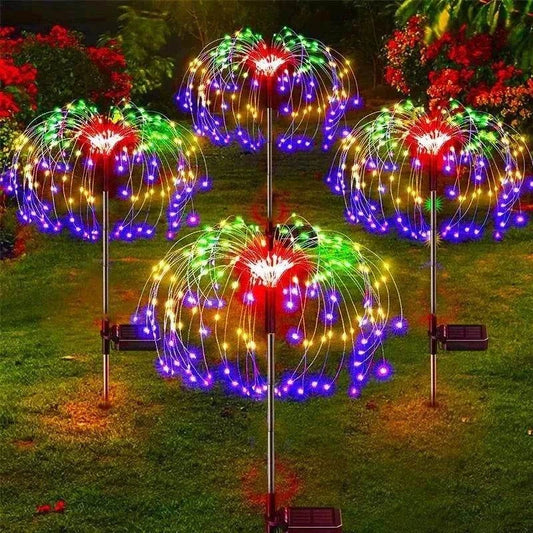 Dandelion Firework Lights with colorful multicolor LED bulbs on metal stems, glowing vibrant purple, red, green, and yellow outdoors at night