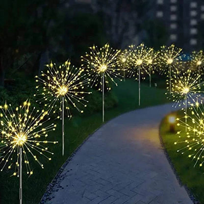 Dandelion Firework Lights featuring warm white LED bulbs arranged in dandelion-like bursts along a garden pathway at night