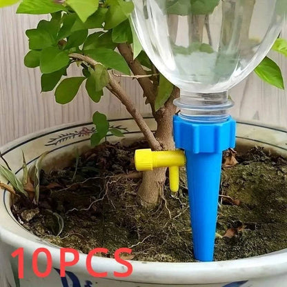 Flower Adjustable Drip Tool in blue and yellow plastic delivering water gradually to potted plant soil for controlled hydration