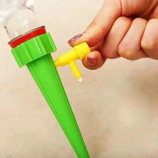 Flower Adjustable Drip Tool with green plastic spike and yellow adjustable valve controlling water flow from a bottle