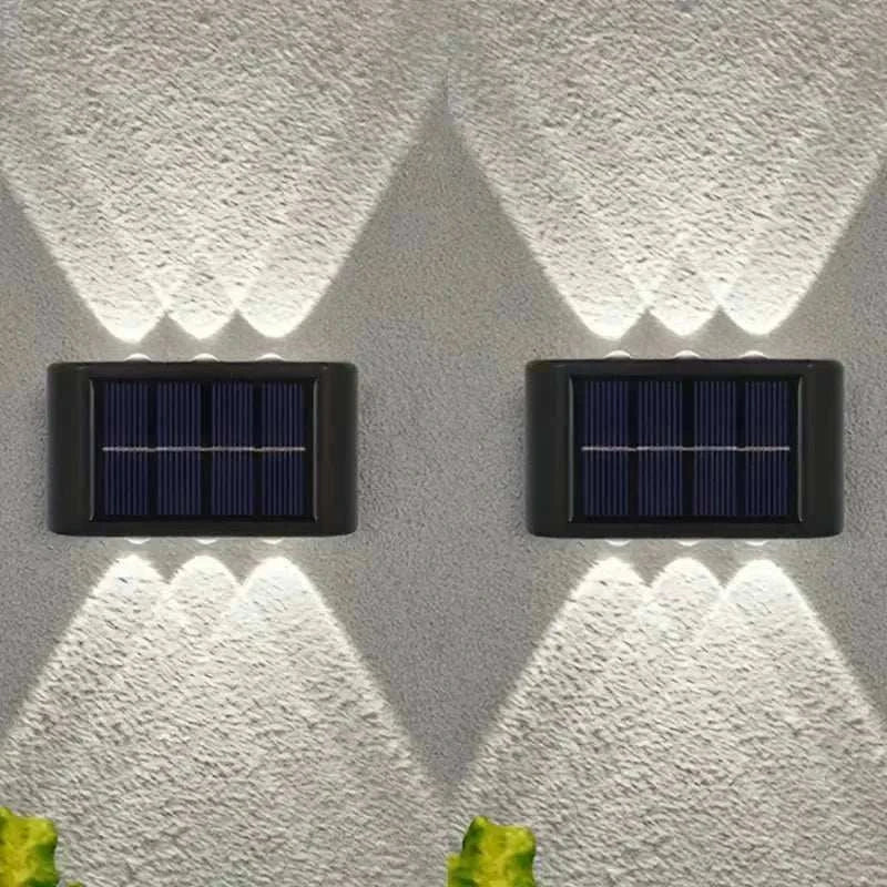 Outdoor Waterproof Fence Lamp with black casing and integrated solar panel, mounted on textured wall, casting upward and downward white light patterns