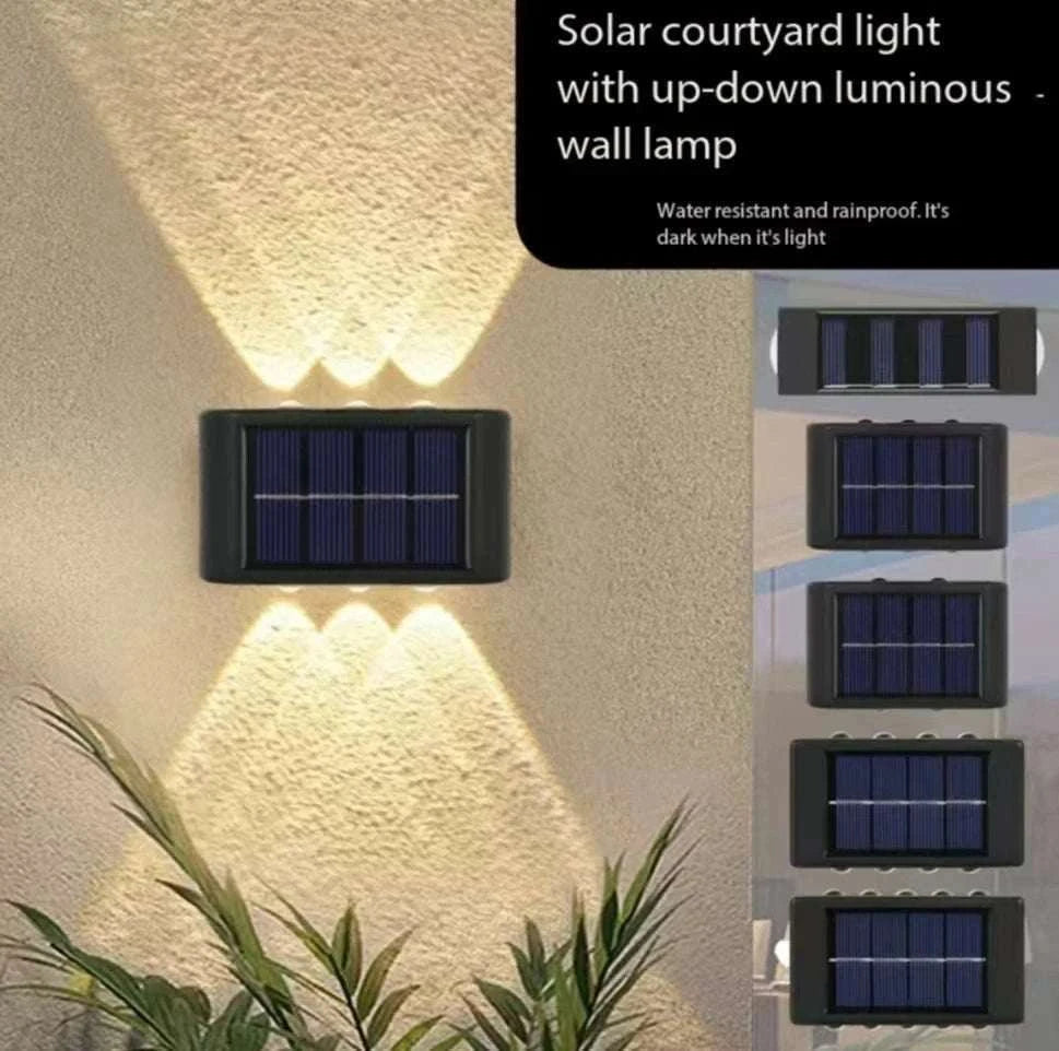 Outdoor Waterproof Fence Lamp in black with solar panel and up-down luminous LED lights casting patterns on wall