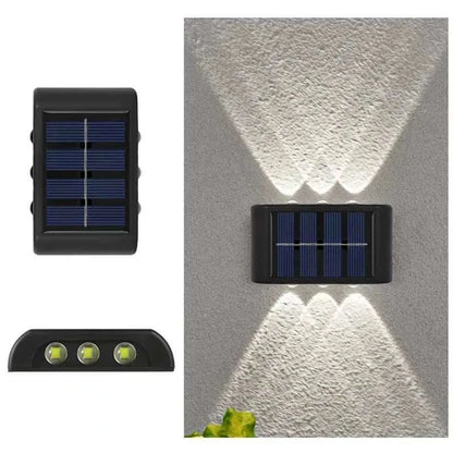 Outdoor Waterproof Fence Lamp with black casing, solar panels, and triple LED lights casting decorative beams on a wall
