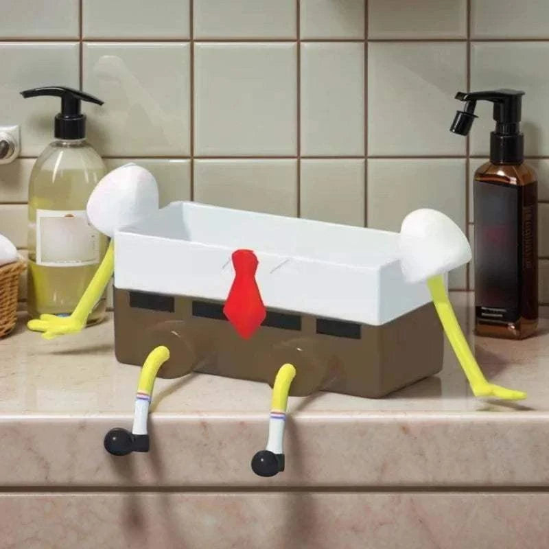 Sink Shelf Drainage organizer rack shaped like a cartoon character with white top, brown base, red tie, and yellow limbs on kitchen counter
