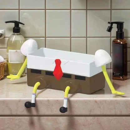 Sink Shelf Drainage organizer rack shaped like a cartoon character with white top, brown base, red tie, and yellow limbs on kitchen counter