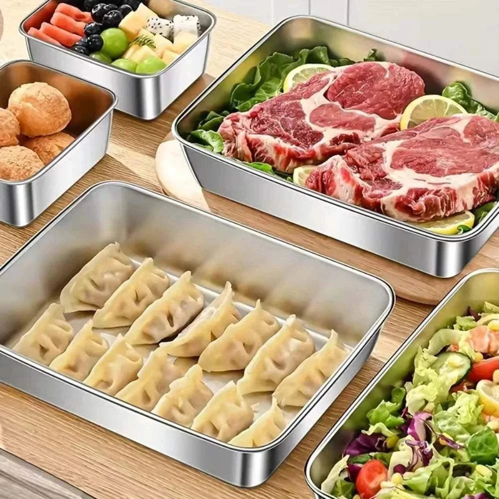 Stainless Steel Food Storage Container with raw meat, salad, dumplings, mixed fruits, and bread rolls in separate compartments on a wooden surface
